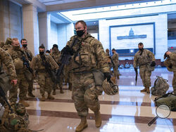 Hundreds of National Guard troops hold inside the Capitol Visitor's Center to reinforce security at the Capitol in Washington, Wednesday, Jan. 13, 2021. The House of Representatives is pursuing an article of impeachment against President Donald Trump for his role in inciting an angry mob to storm the Capitol last week. (AP Photo/J. Scott Applewhite)