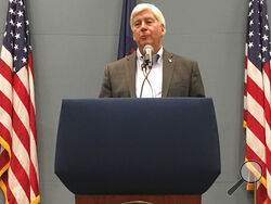 FILE - In this Tuesday, Sept. 25, 2018, file photo, then-Michigan Gov. Rick Snyder speaks with reporters during a news conference at his office in Lansing, Mich. Former Michigan Gov. Rick Snyder has been charged with two counts of willful neglect of duty in the Flint water crisis. (AP Photo/David Eggert, File)