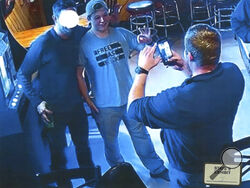 In this image from video provided by the Kenosha County District Attorney, Kyle Rittenhouse poses for a photo at Pudgy's Pub in Mount Pleasant, Wis., on Jan. 5, 2021, the day he was arraigned on charges related to the killing of two people at an August protest in Kenosha. Prosecutors presented this photo and others as evidence of Rittenhouse consorting with white supremacists, citing the use of the “OK” sign, which has been co-opted as a sign of “white power.” Rittenhouse's attorney said he is not and has n