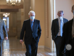 On the first full day of the new Democratic majority in the Senate, Sen. Mitch McConnell, R-Ky., the top Republican, walks to the chamber for the start of business as the minority leader, at the Capitol in Washington, Thursday, Jan. 21, 2021. There is now a 50-50 split between Republicans and Democrats, but with Democratic Vice President Kamala Harris as the tie-breaker, the majority shifts by the slimmest of margins. (AP Photo/J. Scott Applewhite)