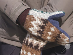 FILE - In this Jan. 20, 2021 file photo, Sen. Bernie Sanders, I-Vt., wears mittens as he attends President Joe Biden's inauguration ceremony at the U.S. Capitol in Washington. Sanders says the wooly mittens he wore to the ceremony that sparked endless quirky memes across social media have helped to raise $1.8 million in the last five days for charitable organizations in his home state of Vermont through the sale of T-shirts, sweatshirts and stickers with the iconic image of him sitting with his arms and leg