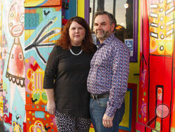 Jennifer and Matt Johnson pose for a portrait in New Orleans, Friday, Jan. 29, 2021. They bought what is now the Carnaval Lounge on St. Claude in summer 2019, and the 2020 Mardi Gras season was their first as business owners. The lounge was becoming popular for live music and Brazilian food. (AP Photo/Dorthy Ray)
