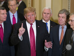 FILE - In this Wednesday, Jan. 9, 2019 file photo, Sen. John Barrasso, R-Wyo., left, and Sen. John Thune, R-S.D., stand with President Donald Trump, Vice President Mike Pence, Sen. Roy Blunt, R-Mo., and Senate Majority Leader Mitch McConnell of Ky., as Trump speaks while departing after a Senate Republican Policy luncheon, on Capitol Hill in Washington. The Republican Party still belongs to Donald Trump. The GOP privately flirted with purging the norm-shattering former president after he incited a deadly ri