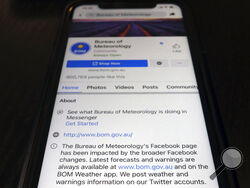 A disclaimer is shown on the bottom of Australia's Bureau of Meteorology page on the Facebook app Thursday, Feb. 18, 2021, in Tokyo. Australia's government has condemned Facebook over its shock move to prevent Australians sharing news that had also blocked some government communications. The Bureau of Meteorology's weather warnings, a Hobart women's shelter and the Betoota Advocate, a satirical website named after an Australian ghost town, were among those surprised to find their content blocked at least te