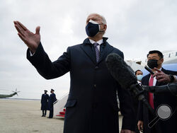 President Joe Biden speaks to member of the media after exiting Air Force One, Friday, Feb. 19, 2021, in Andrews Air Force Base, Md. (AP Photo/Evan Vucci)