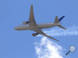 This Saturday, Feb. 20, 2021 photo provided by Hayden Smith shows United Airlines Flight 328 approaching Denver International Airport, after experiencing "a right-engine failure" shortly after takeoff from Denver. Federal regulators are investigating what caused a catastrophic engine failure on the plane that rained debris on Denver suburbs as the aircraft made an emergency landing. Authorities said nobody aboard or on the ground was hurt despite large pieces of the engine casing that narrowly missed homes 