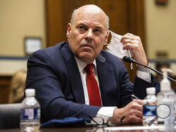 United States Postal Service Postmaster General Louis DeJoy looks on during a House Oversight and Reform Committee hearing on "Legislative Proposals to Put the Postal Service on Sustainable Financial Footing" on Capitol Hill, Wednesday, Feb. 24, 2021, in Washington. (Graeme Jennings/Pool via AP)