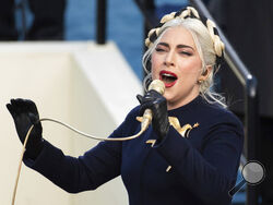 FILE - In this Wednesday, Jan. 20, 2021 file photo, Lady Gaga sings the national anthem during President-elect Joe Biden's inauguration at the U.S. Capitol in Washington. Lady Gaga's two French bulldogs, which were stolen by thieves who shot and wounded the dogwalker, were recovered unharmed Friday, Feb. 26, 2021 Los Angeles police said.(AP Photo/Saul Loeb, Pool)