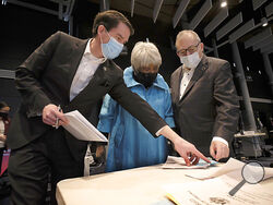 Sen. Jeremy McPike, D-Prince William, left, Sen. Louise Lucas, D-Portsmouth, center and Sen. Adam Ebbin, D-Alexandria, right, confer on marijuana legislation before the floor session of the Virginia Senate, which is meeting inside the Science Museum of Virginia in Richmond, Va., Saturday, Feb. 27, 2021. (Bob Brown/Richmond Times-Dispatch via AP)