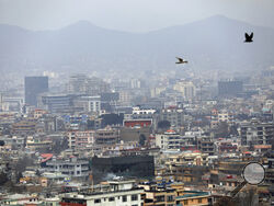 FILE - In this Feb. 1, 2021 file photo, birds flyover the city of Kabul, Afghanistan. The United States wasted billions of dollars in war-torn Afghanistan on buildings and vehicles that were either abandoned or destroyed, according to a report released Monday, March 1, 2021, by the Special Inspector General for Afghanistan Reconstruction, a U.S. government watchdog. (AP Photo/Rahmat Gul, File)