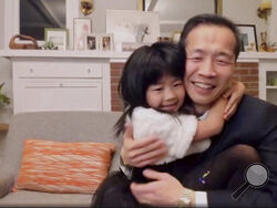 In this video grab issued Sunday, Feb. 28, 2021, by NBC, director Lee Isaac Chung is hugged by his daughter as he accepts the award for best foreign language motion picture for "Minari" from the United States at the Golden Globe Awards. (NBC via AP)