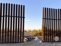 This photo provided by the US Customs and Border Protection shows a hole cut into Southern California's border fence with Mexico on Wednesday, March 3, 2021. Thirteen people killed in one of the deadliest border crashes on record were among more than 40 migrants who entered the U.S. through the hole cut into Southern California's border fence with Mexico, the Border Patrol said Wednesday. (US Customs and Border Protection via AP)