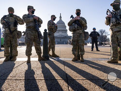 Members of the Michigan National Guard and the U.S. Capitol Police keep watch as heightened security remains in effect around the Capitol grounds since the Jan. 6 attacks by a mob of supporters of then-President Donald Trump, in Washington, Wednesday, March 3, 2021. The U.S. Capitol Police say they have intelligence showing there is a "possible plot" by a militia group to breach the Capitol on Thursday. (AP Photo/J. Scott Applewhite)