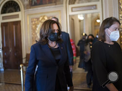 Vice President Kamala Harris arrives to break the tie on a procedural vote as the Senate works on the Democrats' $1.9 trillion COVID relief package, on Capitol Hill in Washington, Thursday, March 4, 2021. (AP Photo/J. Scott Applewhite)