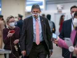 FILE - In this Feb. 25, 2021, file photo, reporters question Sen. Joe Manchin, D-W.Va., as he arrives for votes on President Joe Biden's cabinet nominees, at the Capitol in Washington. (AP Photo/J. Scott Applewhite, File)