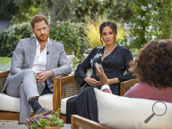 This image provided by Harpo Productions shows Prince Harry, left, and Meghan, Duchess of Sussex, in conversation with Oprah Winfrey. "Oprah with Meghan and Harry: A CBS Primetime Special" airs March 7, 2021. Britain’s royal family and television have a complicated relationship. The medium has helped define the modern monarchy: The 1953 coronation of Queen Elizabeth II was Britain’s first mass TV spectacle. Since then, rare interviews have given a glimpse behind palace curtains at the all-too-human family w
