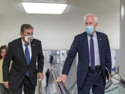 Sen. Joe Manchin, D-W.Va., left, and Sen. John Cornyn, R-Texas, head to the chamber as the Senate steers toward a voting marathon on the Democrats' $1.9 trillion COVID-19 relief bill that's expected to end with the chamber's approval of the measure, at the Capitol in Washington, Friday, March 5, 2021. (AP Photo/J. Scott Applewhite)