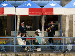 FILE - In this March 3, 2021, file photo, mariachi perform for diners at a restaurant on the River Walk in San Antonio. (AP Photo/Eric Gay, File)
