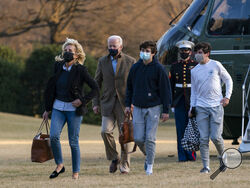 President Joe Biden and first lady Jill Biden with their grandson Hunter Biden, walk on the South Lawn upon arrival at the White House in Washington from a weekend trip to Wilmington, Del., Sunday, March 14, 2021. (AP Photo/Manuel Balce Ceneta)