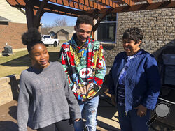 Brilee Carter, left,13, and Cobe Calhoun, 17, share a laugh with their great-grandmother, Doris Rolark, outside Rolark's daughter's home on March 7, 2021, in Monroe, Ohio. The pandemic and its isolating restrictions have been especially tough for many of the nation's some 70 million grandparents, many at ages when they are considered most vulnerable to the deadly COVID-19 virus. Rolark, of Middletown, Ohio, has always been active with the offspring. She raised three children mostly on her own, had five gran