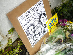 Flowers, candles and signs are displayed at a makeshift memorial outside of the Gold Spa in Atlanta, Wednesday, March 17, 2021. According to authorities, three Asian women were found dead inside of the Gold Spa on Tuesday night and another Asian woman was found dead at Aromatherapy Spa across the street. Police in the Atlanta suburb of Gwinnett County say they've begun extra patrols in and around Asian businesses there following the shooting at three massage parlors in the area that killed eight, most of th