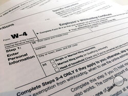 FILE - In this Feb. 5, 2020, file photo, a W-4 form is viewed in New York. The IRS will delay the traditional April 15 tax filing due date until May 17, 2021, to cope with added duties and provide Americans more flexibility. (AP Photo/Patrick Sison, File)