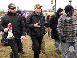 In this Jan. 6, 2021, photo, Proud Boys members Ethan Nordean, left, Zachary Rehl and Joseph Biggs walk toward the U.S. Capitol in Washington, in support of President Donald Trump. Four men described by prosecutors as leaders of the far-right Proud Boys have been indicted on charges that they planned and carried out a coordinated attack on the U.S. Capitol to stop Congress from certifying President Joe Biden's electoral victory. Nordean and Biggs, two of the four defendants charged in the latest indictment,
