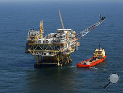 FILE - This Sunday, April 10, 2011 picture shows a rig and supply vessel in the Gulf of Mexico, off the cost of Louisiana. Thirteen states sued the Biden administration Wednesday, March 24, 2021 to end a suspension of new oil and gas leases on federal land and water and to reschedule canceled sales of offshore leases in the Gulf of Mexico, Alaska waters and western states. The Republican-leaning states, led by Louisiana Attorney General Jeff Landry, seek a court order ending the moratorium imposed after Dem