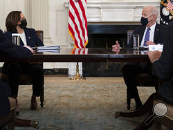 President Joe Biden speaks with Vice President Kamala Harris about the southern border during a meeting in the State Dining Room of the White House, Wednesday, March 24, 2021, in Washington. (AP Photo/Evan Vucci)