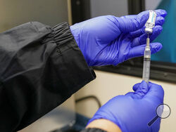 A nurse fills a syringe with a dose of the Johnson & Johnson's one-dose COVID-19 vaccine at the Vaxmobile, at the Uniondale Hempstead Senior Center, Wednesday, March 31, 2021, in Uniondale, N.Y. The Vaxmobile, is a COVID-19 mobile vaccination unit, sponsored by a partnership between Mount Sinai South Nassau and Town of Hempstead to bring the one-dose vaccine directly to hard-hit communities in the area. (AP Photo/Mary Altaffer)