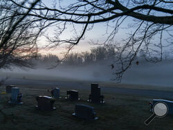 FILE - In this Wednesday, March 17, 2021 file photo, morning fog blankets a cemetery in West Virginia. The number of U.S. suicides fell nearly 6% in 2020 amid the coronavirus pandemic — the largest annual decline in at least four decades, according to preliminary government data. (AP Photo/David Goldman)