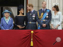 FILE - In this file photo dated Tuesday, July 10, 2018, Britain's Queen Elizabeth II, and from left, Meghan the Duchess of Sussex, Prince Harry, Prince William and Kate the Duchess of Cambridge, watch as Royal Air Force aircraft pass over Buckingham Palace in London. Prince Harry will attend the funeral for Prince Philip on Saturday April 17, the first time that Harry will come face to face with the royal family since he and his wife Meghan, the Duchess of Sussex, stepped away from royal duties last March a