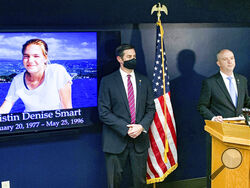 San Luis Obispo District Attorney Dan Dow announces a murder charge is filed against Paul Flores in the Kristin Smart case, as Deputy District Attorney Chris Peuvrelle listens at left, during a news conference, Wednesday, April 14, 2021, in Arroyo Grande, Calif. Smart, a missing California college who was killed in 1996 during an attempted rape by a fellow student, and the suspect’s father helped hide her body, the San Luis Obispo County district attorney said Wednesday. (David Middlecamp/The Tribune (of Sa