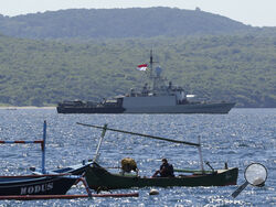 Indonesian Navy ship KRI Singa sails to take part in the search for submarine KRI Nanggala that went missing while participating in a training exercise on Wednesday, off Banyuwangi, East Java, Indonesia, Thursday, April 22, 2021. Indonesia's navy ships are intensely searching the waters where one of its submarines was last detected before it disappeared, as neighboring countries are set to join the complex operation. (AP Photo)
