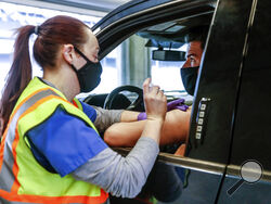 Pharmacy Technician Synclaire Anderson vaccinates Joe Freed with the Johnson & Johnson COVID-19 on Saturday, April 24, 2021 at The Indianapolis Motor Speedway in Indianapolis. With a green light from federal health officials, several states resumed use of the one-shot Johnson & Johnson coronavirus vaccine on Saturday. Among the venues where it's being deployed is the Indianapolis Motor Speedway, where free vaccinations were available to anyone 18 or older. (Michelle Pemberton/The Indianapolis Star via AP)