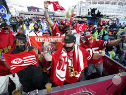 A group of San Francisco 49ers fans cheer as they await the NFL football draft, Thursday, April 29, 2021, in Cleveland. (AP Photo/Tony Dejak)