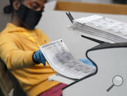FILE - In this Nov. 5, 2020, file photo, a county election worker scans mail-in ballots at a tabulating area at the Clark County Election Department in Las Vegas. The U.S. Census says more than two-thirds of U.S. citizens cast a ballot in the 2020 presidential election. And 7 out of 10 who voted did so by mail or at a polling place before Election Day. (AP Photo/John Locher, File)