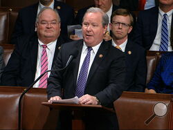 FILE - In this Dec. 18, 2019, file photo, Rep. Larry Bucshon, R-Ind., speaks on the House floor at the Capitol in Washington. With vaccination rates lagging in red states, Republican leaders have begun stepping up efforts to persuade their supporters to get the shot, at times combating misinformation spread by some of their own. (House Television via AP)