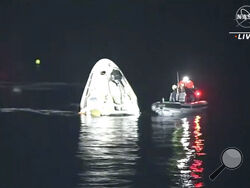 In this image made from NASA TV video, the SpaceX Dragon capsule floats after landing in the Gulf of Mexico near the Florida Panhandle early Sunday, May 2, 2021. SpaceX returned four astronauts from the International Space Station on Sunday, making the first U.S. crew splashdown in darkness since the Apollo 8 moonshot. (NASA TV via AP)