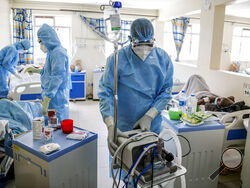 FILE - In this April 14, 2021, file photo, medical workers tend to coronavirus patients in the COVID-19 intensive care unit at Kenyatta National Hospital, in Nairobi, Kenya. Amid concerns over India, Kenya, which is coming down from a recent peak in cases, halted flights with the country for two weeks, while Nigeria suspended flights with India, Brazil and Turkey, fearing new virus strains could come in as it tries to bring down cases, particularly in Lagos, home to some 20 million people. (AP Photo/Brian I