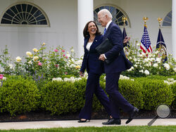 President Joe Biden walks with Vice President Kamala Harris after speaking on updated guidance on face mask mandates and COVID-19 response, in the Rose Garden of the White House, Thursday, May 13, 2021, in Washington. (AP Photo/Evan Vucci)
