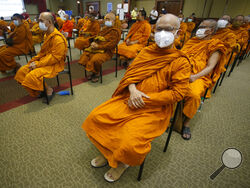 Buddhist monks wait to receive Sinovac COVID-19 vaccines at Priest hospital in Bangkok, Thailand Tuesday, May 18 , 2021. Thailand had about 7,100 cases, including 63 deaths, in all of last year, in what was regarded as a success story. Taxi drivers are starved for customers, weddings are suddenly canceled, schools are closed, and restaurant service is restricted across much of Asia as the coronavirus makes a resurgence in countries where it had seemed to be well under control. (AP Photo/Anuthep Cheysakron)