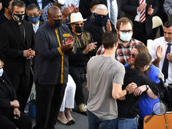 Family members of shooting victim Timothy Romo embrace during a vigil at City Hall in San Jose, Calif., Thursday, May 27, 2021, in honor of the multiple people killed when a gunman opened fire at a rail yard the day before. (AP Photo/Nic Coury)
