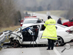FILE - In this Saturday, Jan. 25, 2020, file photo, emergency crews work the scene of a fatal crash involving a charter bus and car on the AA highway in Campbell County, Ky. U.S. traffic deaths rose 7% last year, the biggest increase in 13 years even though people drove fewer miles due to the coronavirus pandemic, the government's road safety agency reported Thursday, June 3, 2021. (Albert Cesare/The Cincinnati Enquirer via AP)