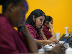 Tnisha Nation, left, Sandrea Guerrero, center, and Elena Mojica reach out to families in the San Antonio Independent School District, Tuesday, June 8, 2021, in San Antonio. School districts that lost enrollment during the pandemic are looking anxiously to the fall to see how many families stick with the education choices they made over the last year. In hopes of boosting enrollment, many districts have launched new efforts to connect with families of young children, including blanketing communities with yar