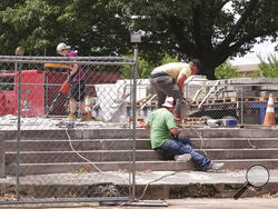 Workers dig up the remains of Confederate Gen. Nathan Bedford Forrest and his wife to move the bodies from Health Sciences Park June 4, 2021, in Memphis, Tenn. With the approval of relatives, the remains will be moved to the National Confederate Museum in Columbia, Tenn. (AP Photo/Karen Pulfer Focht)