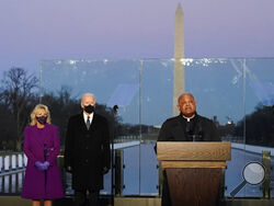 FILE - In this Tuesday, Jan. 19, 2021 file photo, President-elect Joe Biden and his wife, Jill, listen as Cardinal Wilton Gregory, Archbishop of Washington, delivers the invocation during a COVID-19 memorial at the Lincoln Memorial Reflecting Pool in Washington. Gregory has made clear that President Biden, who sometimes worships in Washington, is welcome to receive Communion at the archdiocese's churches. (AP Photo/Alex Brandon, File)