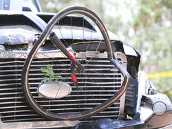 In this Saturday, June 19, 2021, photo courtesy of The White Mountain Independent is a pick up truck which ran over a group of cyclists in Show Low, Ariz. Police say a driver in a pickup truck has plowed into bicyclists competing in a community road race in Arizona, critically injuring several riders. Authorities say officers then chased down the driver Saturday and shot him outside a nearby hardware store. Police say six cyclists have been taken to a hospital in critical condition after the crash. (Jim Hea