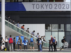 Journalists gather at Multifunctional Complex at the Tokyo 2020 Olympic and Paralympic Village during a media tour Sunday, June 20, 2021, in Tokyo. (AP Photo/Eugene Hoshiko)