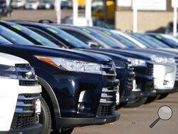 This Nov. 15, 2020 photo shows a long row of unsold used Highlander sports-utility vehicles sits at a Toyota dealership in Englewood, Colo. In 2021, high demand and low supply have driven up used vehicle prices so much that many are now selling for more than their original sticker price when they were new. (AP Photo/David Zalubowski)